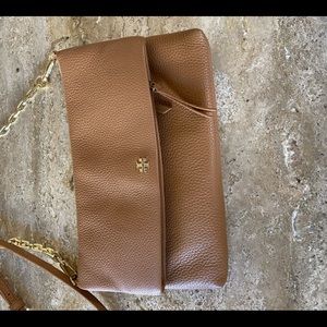 Tory Burch tan crossbody purse with gold accent.